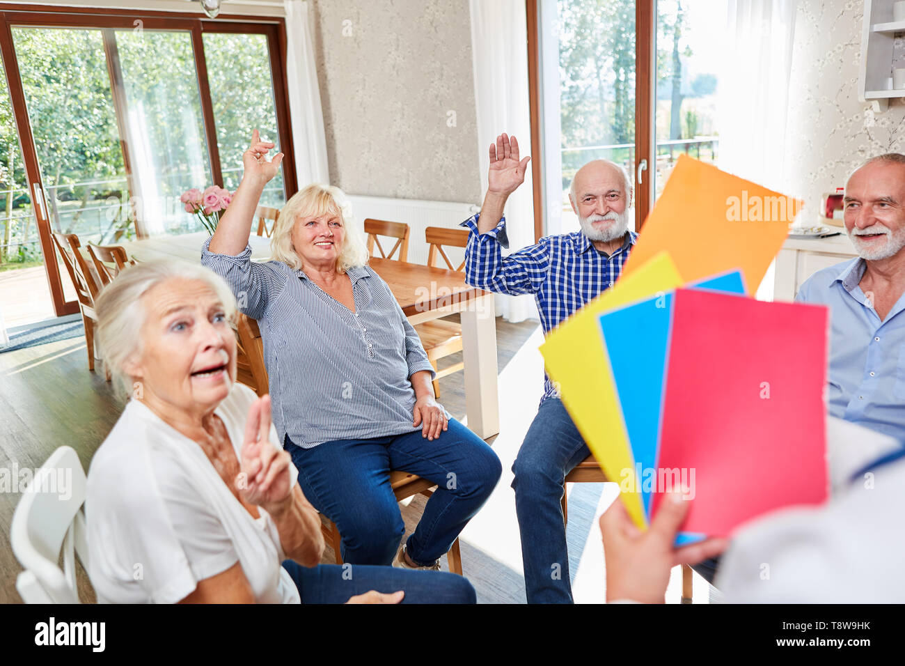 Seniors do an exercise in group psychotherapy at the retirement home Stock Photo