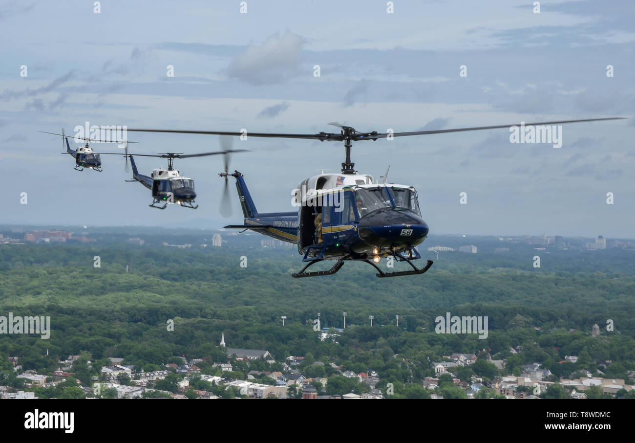 Members of the 1st Helicopter Squadron fly UH1 Hueys over Washington