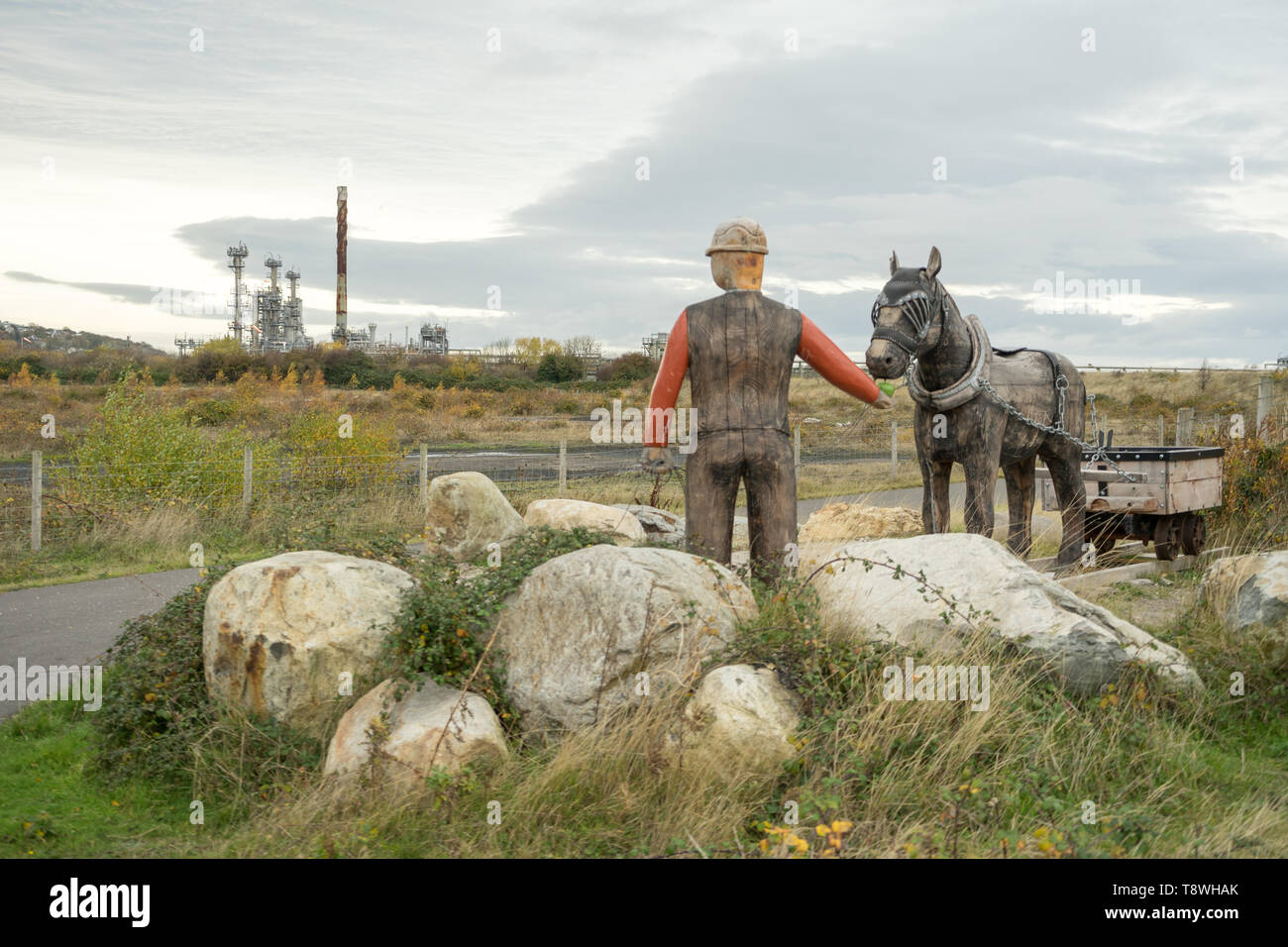Mining, miner memorial, North Wales, UK, overlooking oil field industry Stock Photo