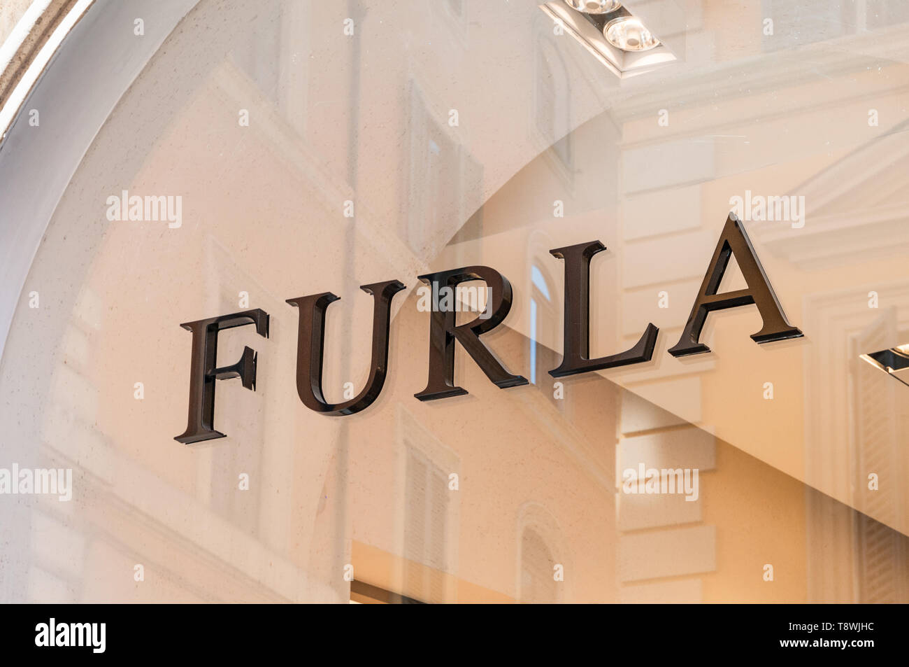 ROME, ITALY - SEPTEMBER 4, 2010: The entrance of the Furla fashion store with logo on the Via del Condotti  in Rome with the houses on the opposite si Stock Photo