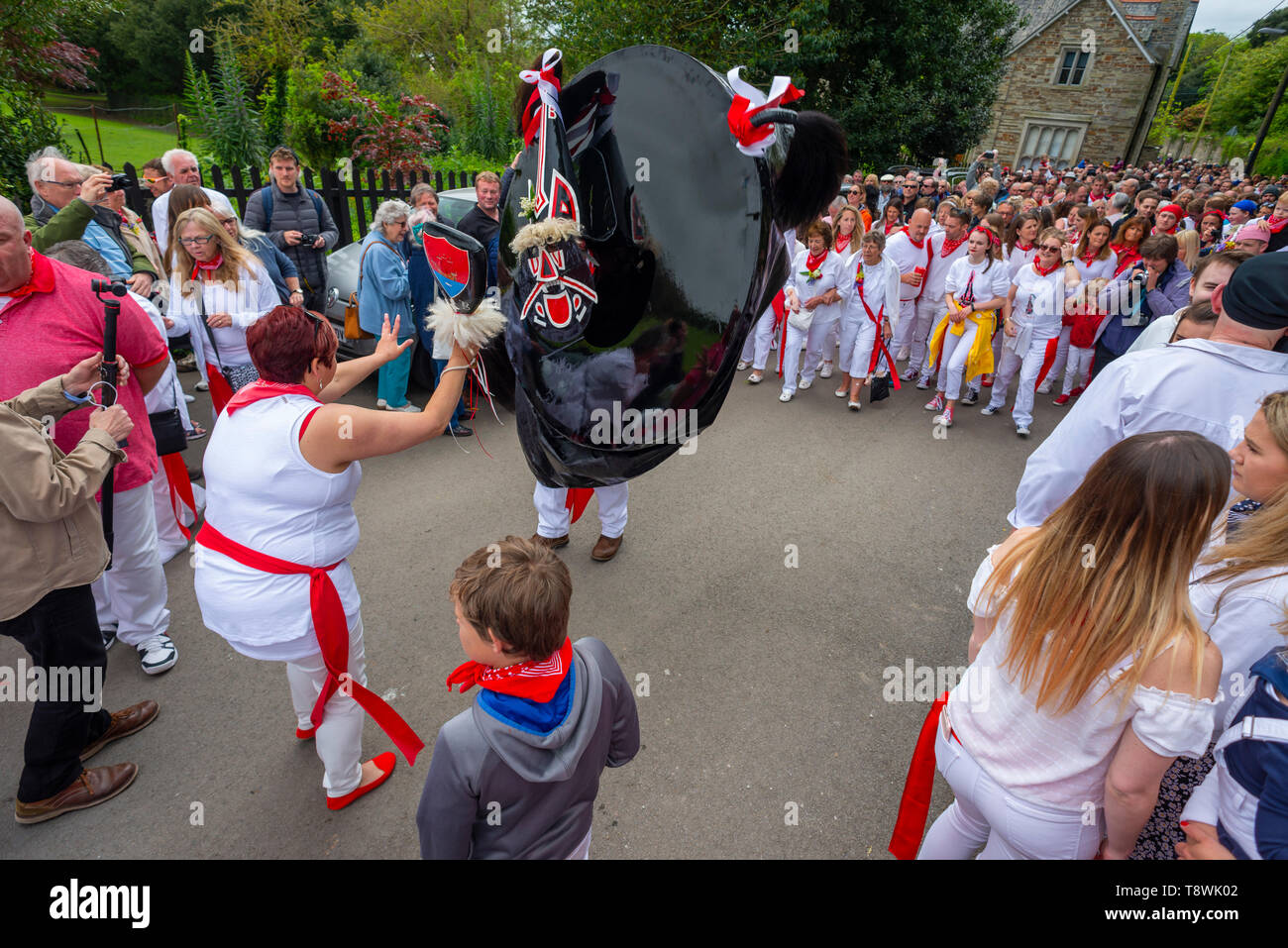 Editorial: Unknow members of the public and potential logos and signage. Padstow, Cornwall. 01/05/2019, The Obby Oss parade is a centuries old tradtio Stock Photo