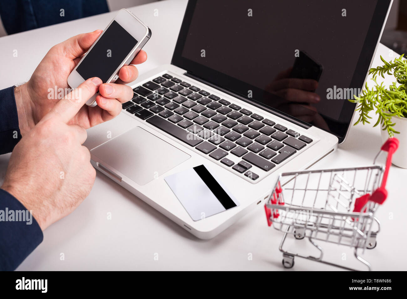 A man is going to pay for the goods in the internet using credit card ...