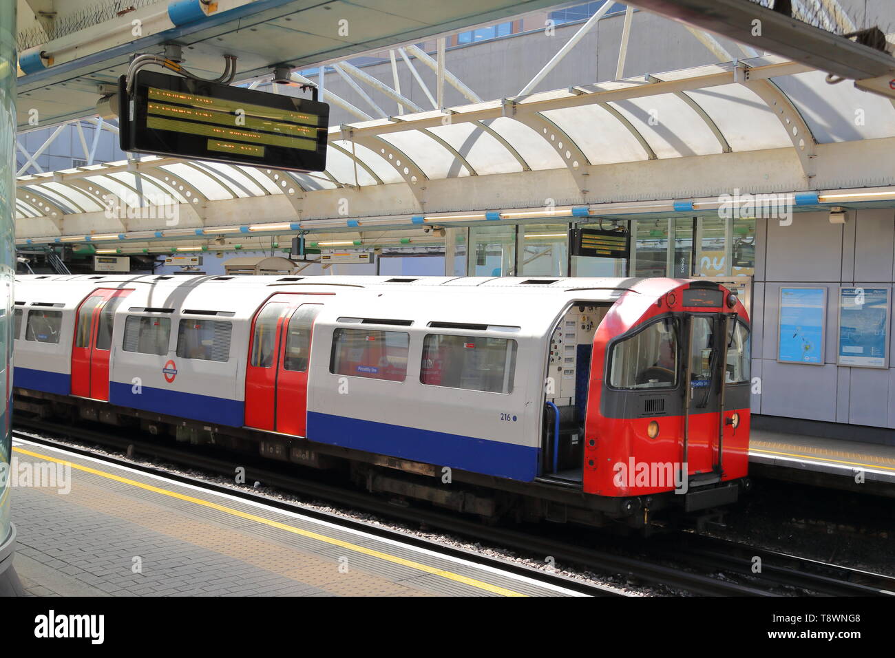 An Underground train arriving at Hammersmith tube station, London, UK Stock Photo