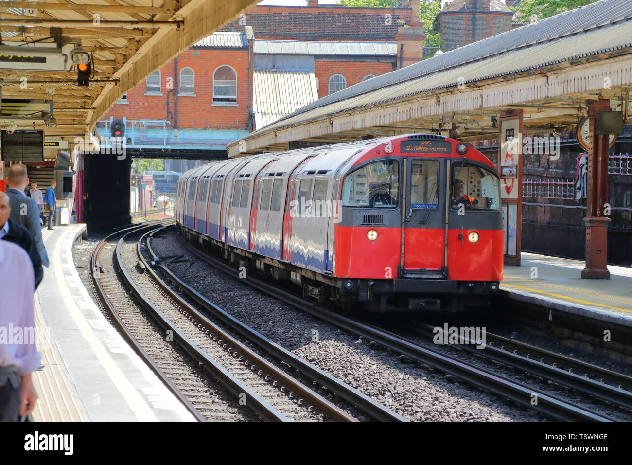 An Underground train arriving at Hammersmith tube station, London, UK Stock Photo