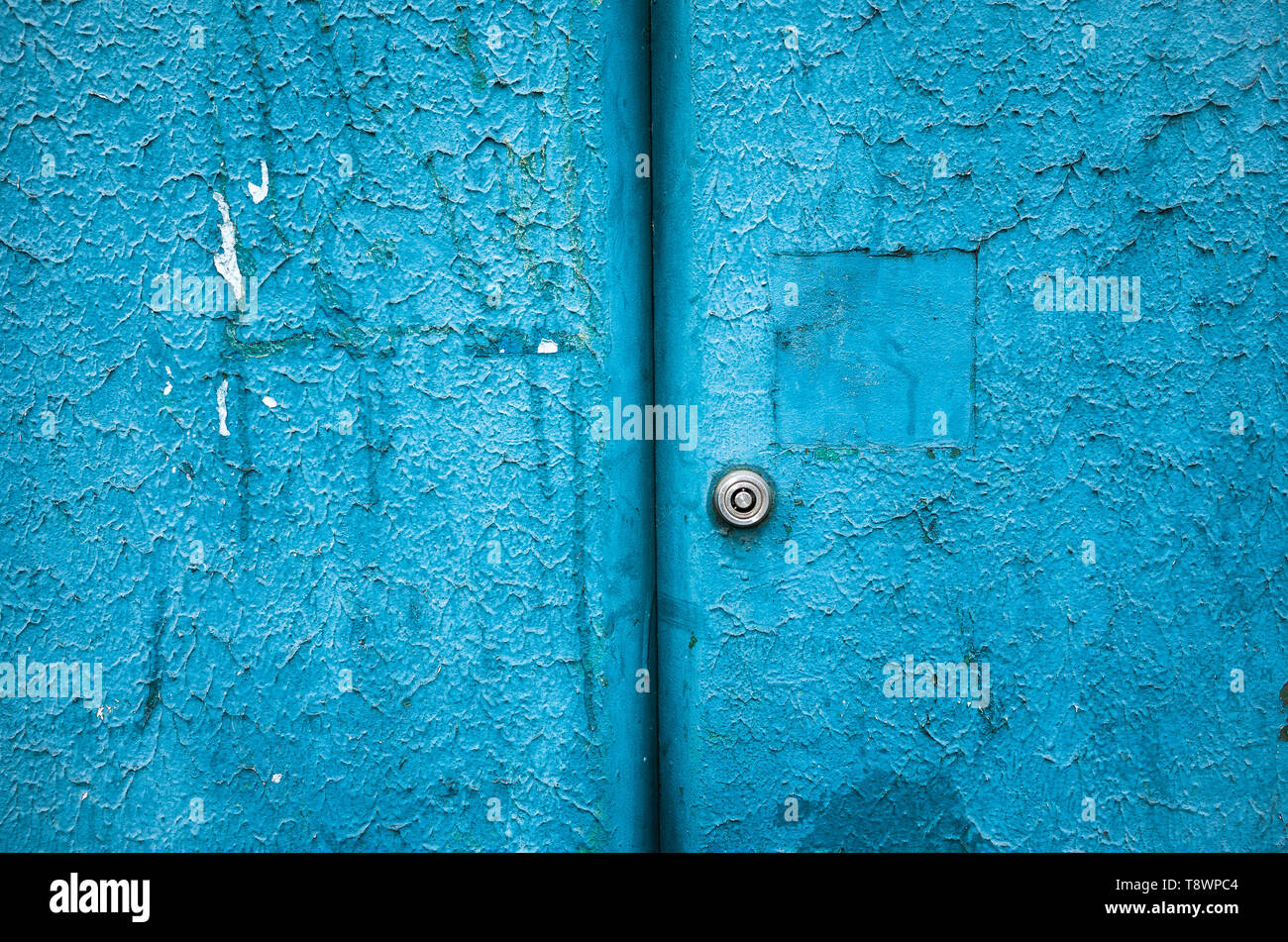 Textured, grungy blue cabinet door with keyhole. Stock Photo
