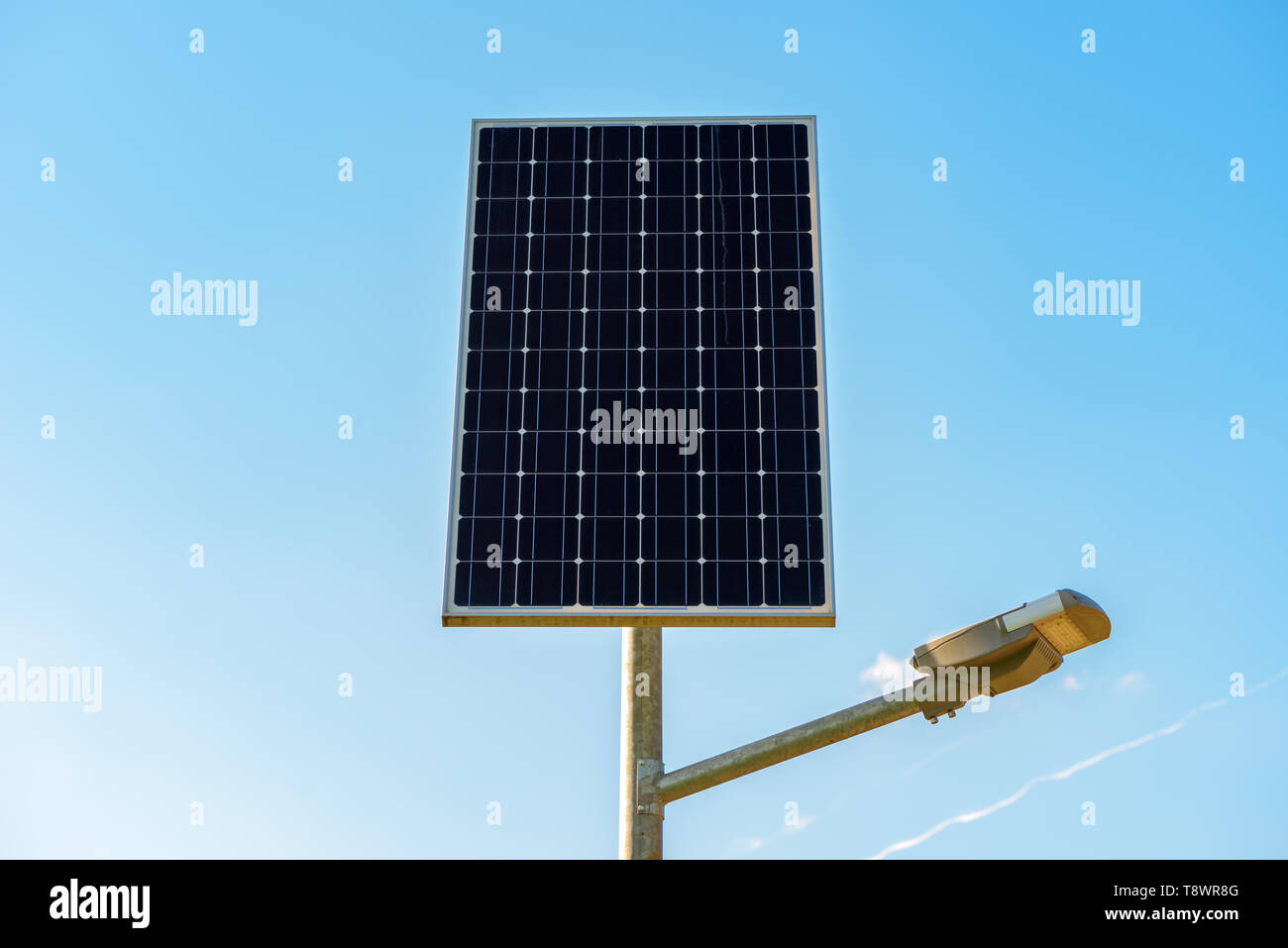 Single solar panel on the post against blue sky Stock Photo