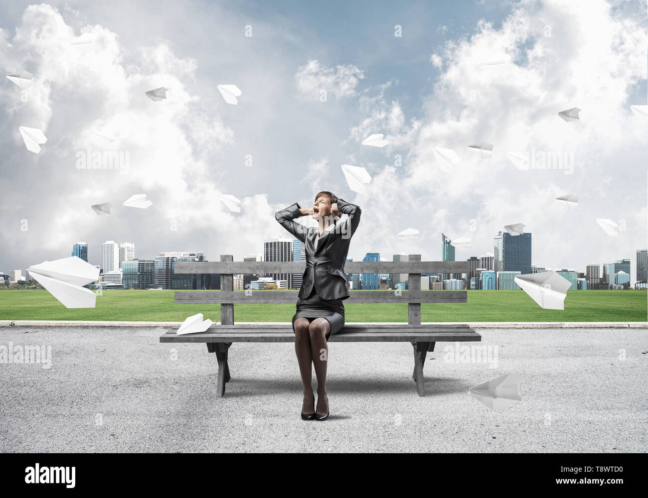 Stressful woman sitting on wooden bench Stock Photo