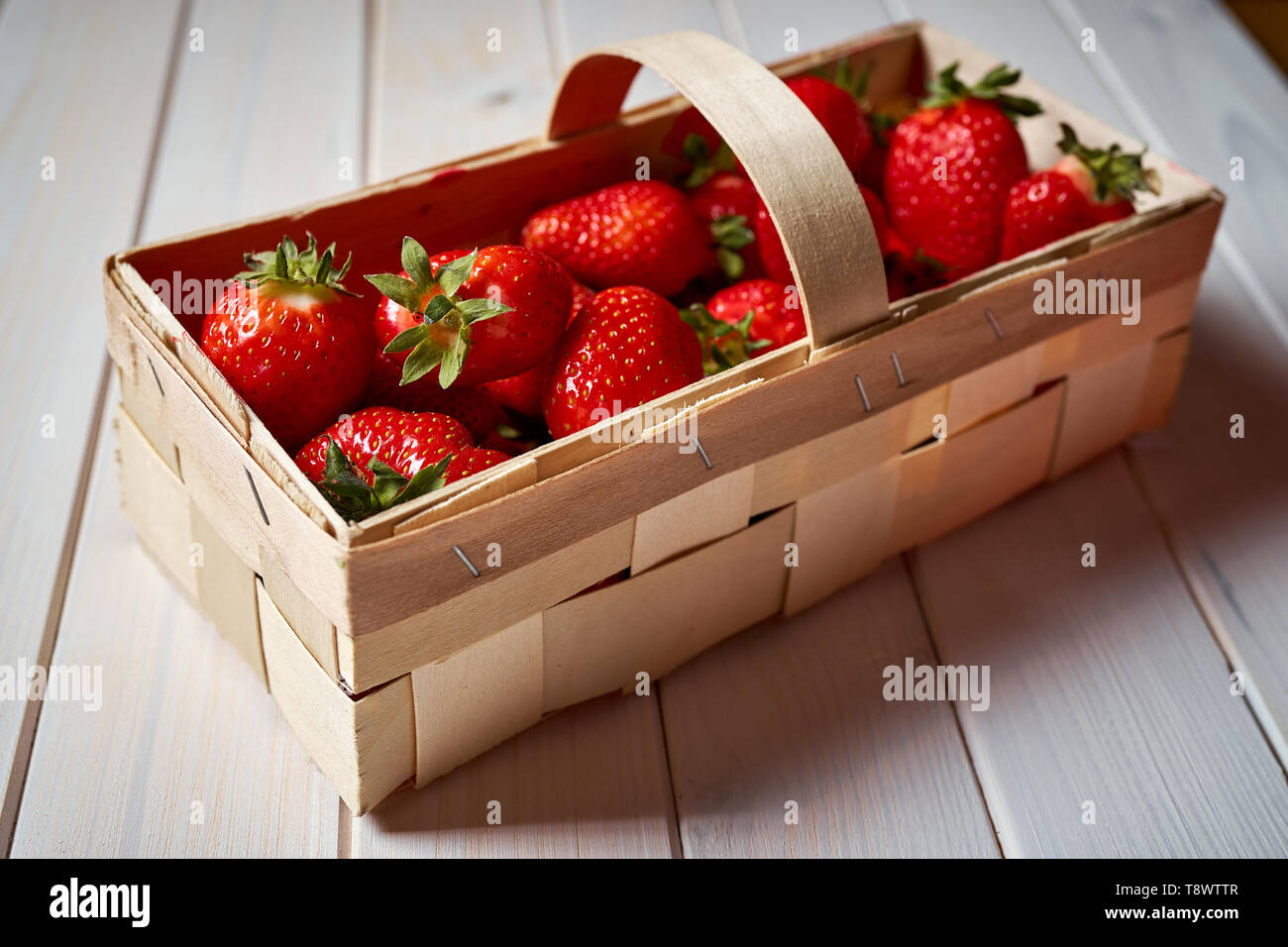 fresh juicy red strawberries in basket on white table Stock Photo - Alamy