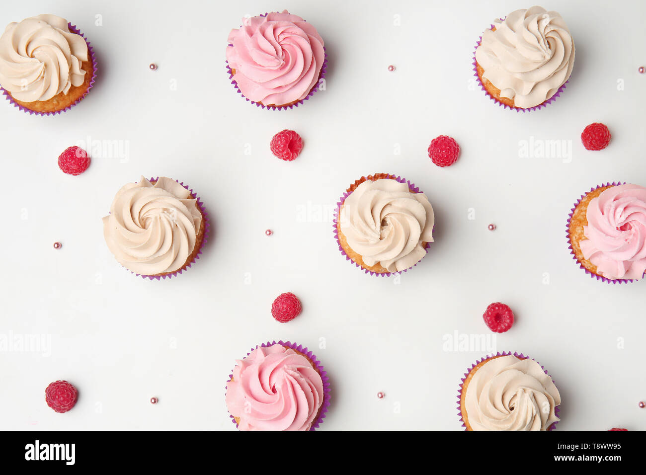 Delicious cupcakes on white background, flat lay Stock Photo