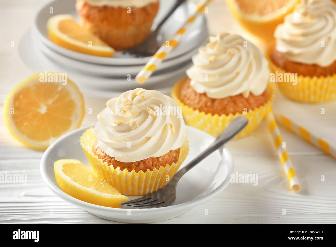 Plate with delicious lemon cupcake on white table Stock Photo