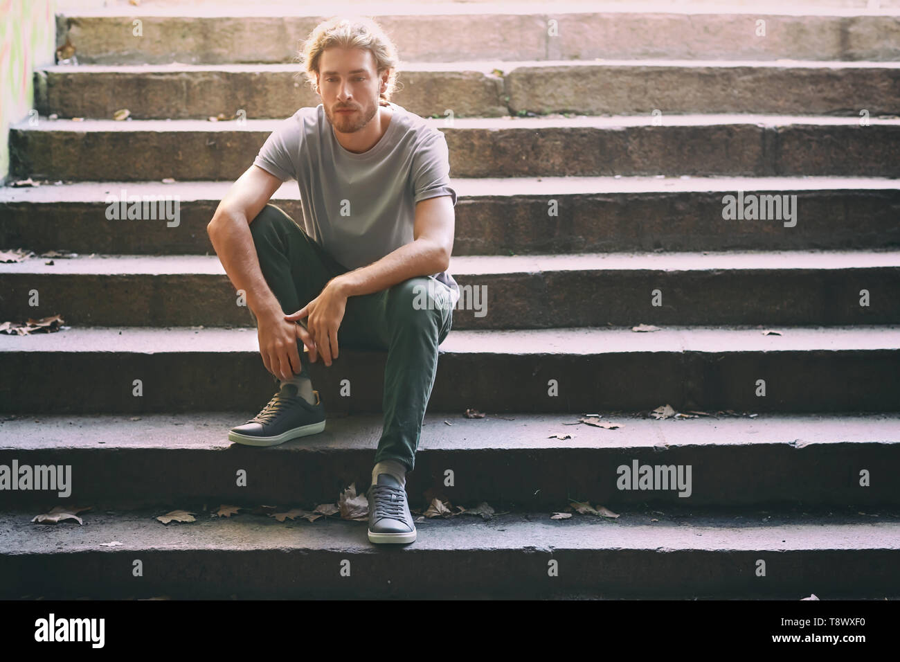 Lonely man sitting on stairs hi-res stock photography and images - Alamy