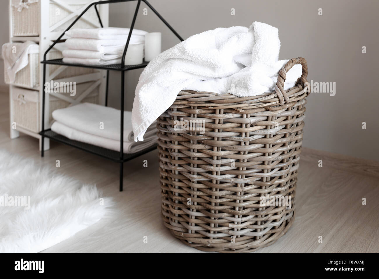 Laundry basket with dirty towels on floor Stock Photo Alamy