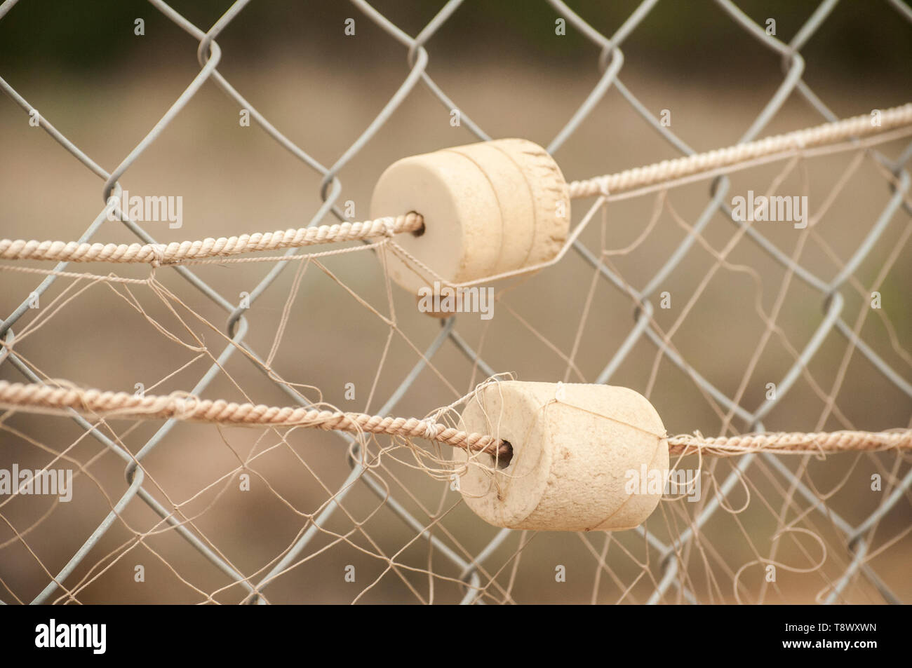Fishing net with cork floats on wire mesh closeup as decorative