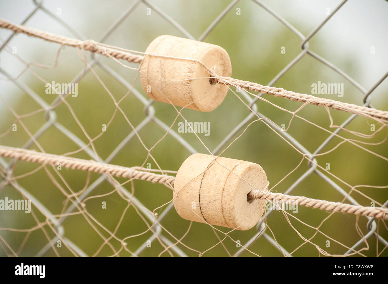 Fishing net with cork floats on wire mesh closeup as decorative background  Stock Photo - Alamy