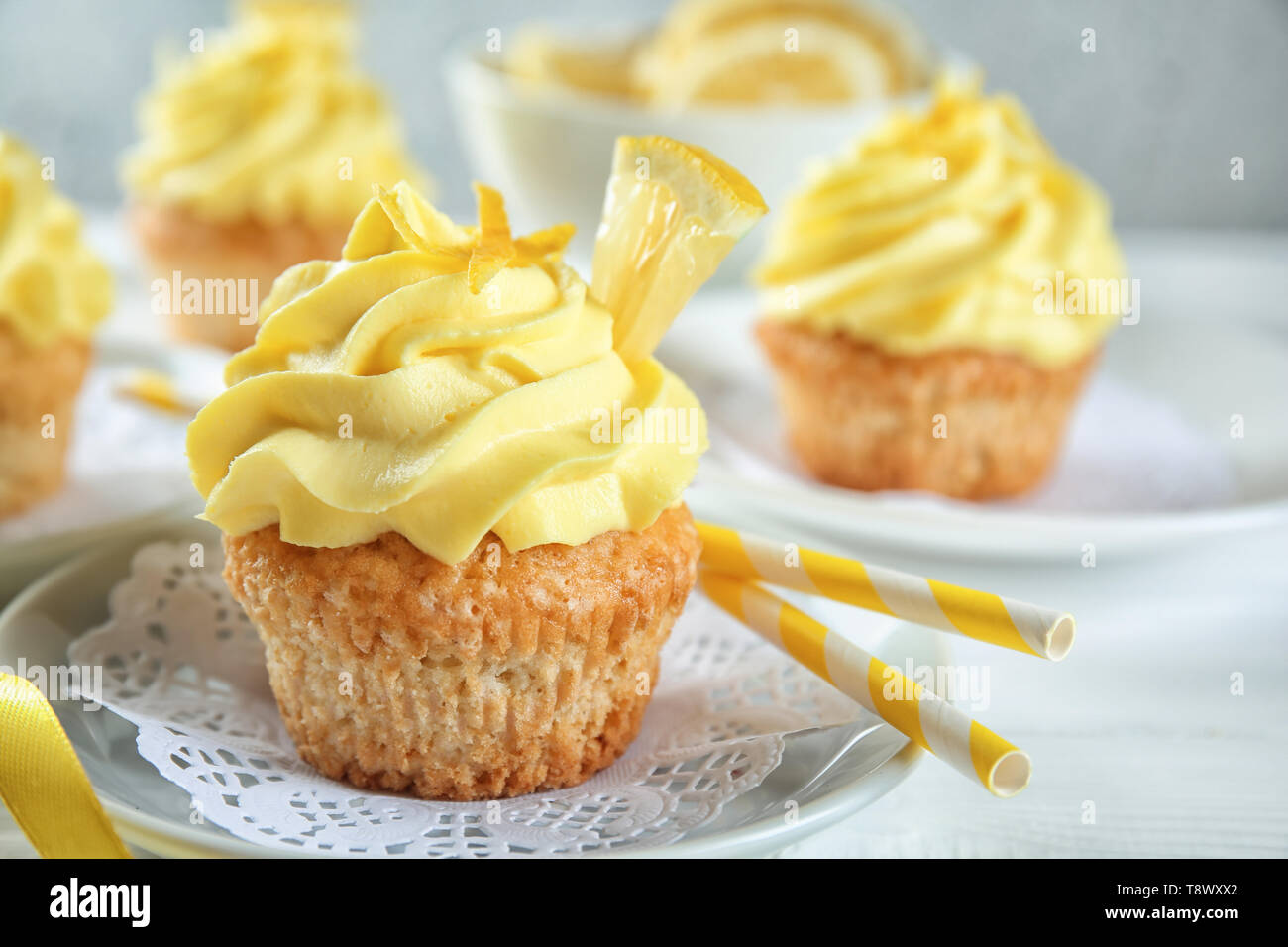 Plate with delicious lemon cupcake on table Stock Photo