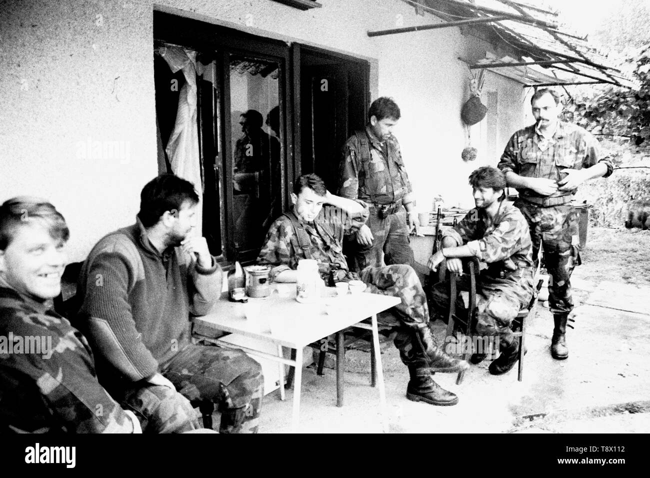 Croatian Defense Forces relax at a house near the front-line in Moscenica during the break-up of the former Yugoslavia in 1991. Picture by Adam Alexander Stock Photo