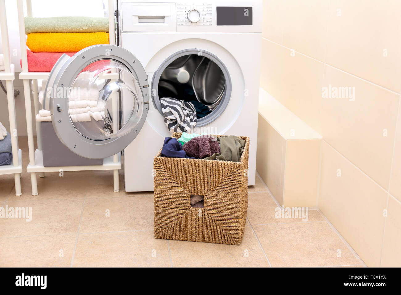 Laundry basket with dirty clothes in bathroom Stock Photo Alamy
