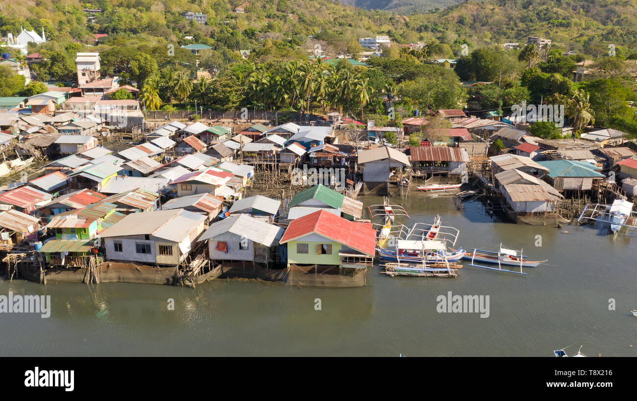 Aerial view Coron city with slums and poor district. Palawan.Wooden houses near the water.Poor neighborhoods and slums in the city of Coron aerial view Stock Photo