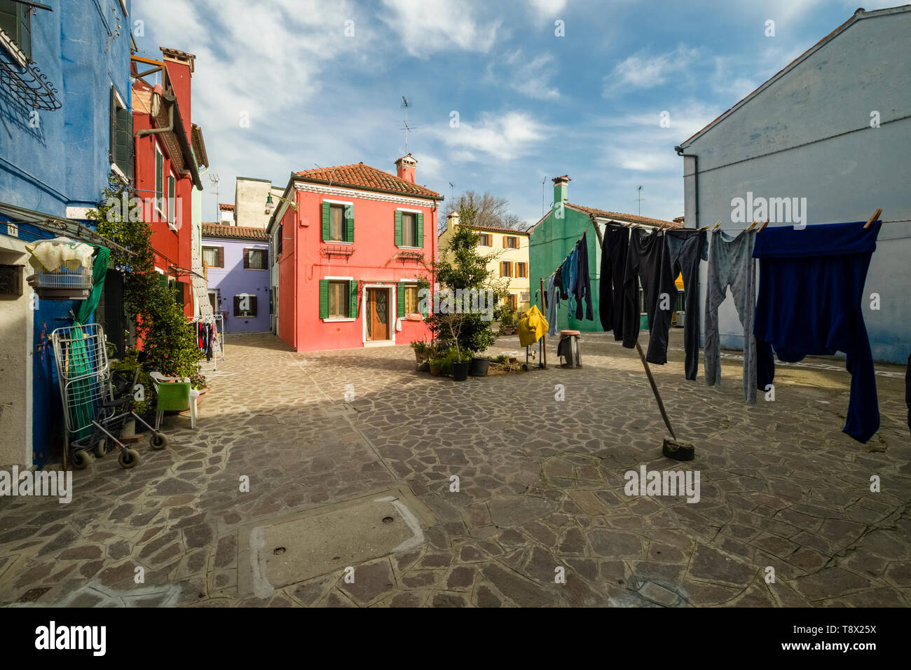 Colorfully painted houses on the island Burano, laundry is put up on washing lines Stock Photo