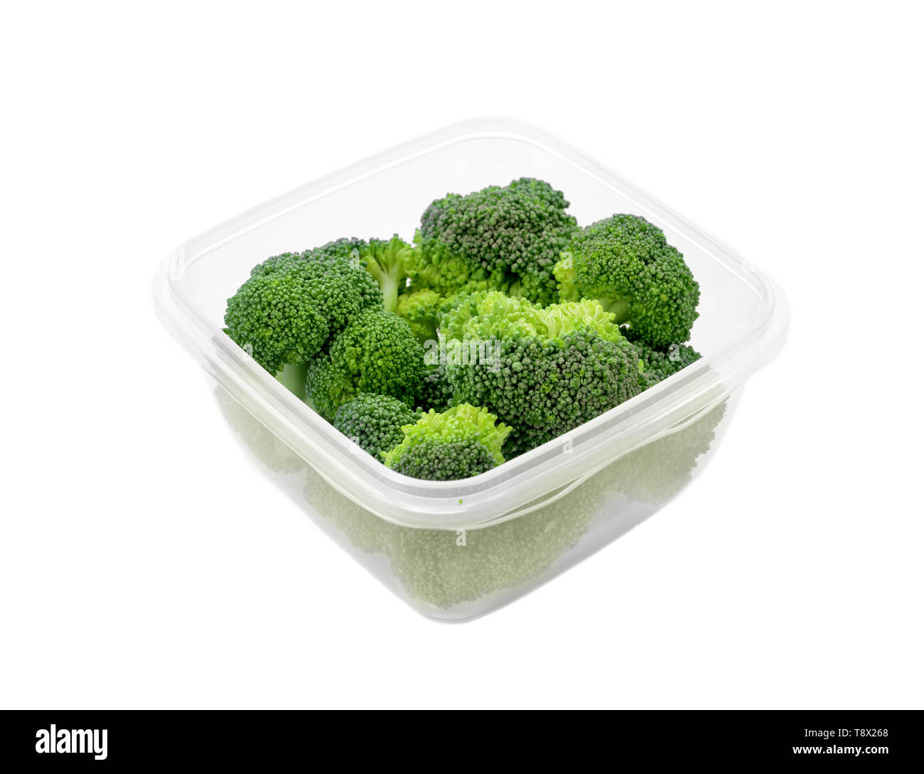Plastic container with fresh broccoli for freezing on white background