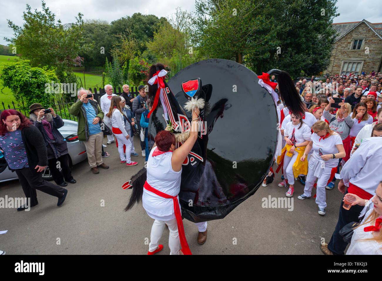 Editorial: Unknow members of the public and potential logos and signage. Padstow, Cornwall. 01/05/2019, The Obby Oss parade is a centuries old tradtio Stock Photo