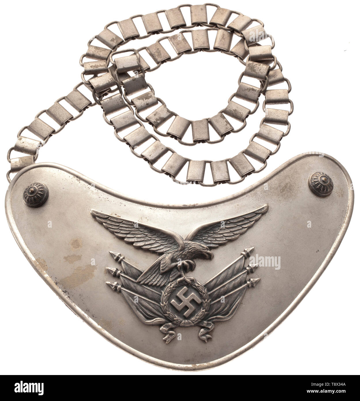 A gorget model 1936 for flag bearers of the Luftwaffe maker 'Juncker Berlin' Half moon-shaped, silvered shield, pin-affixed appliqués with old silver patina: 2nd model Luftwaffe eagle on a bundle of flags and corner rosettes. Liner of Luftwaffe cloth (mothy), the arresting clasp punched 'C.E. Juncker Berlin'. Silvered chain. Very rare. historic, historical, 20th century, Editorial-Use-Only Stock Photo