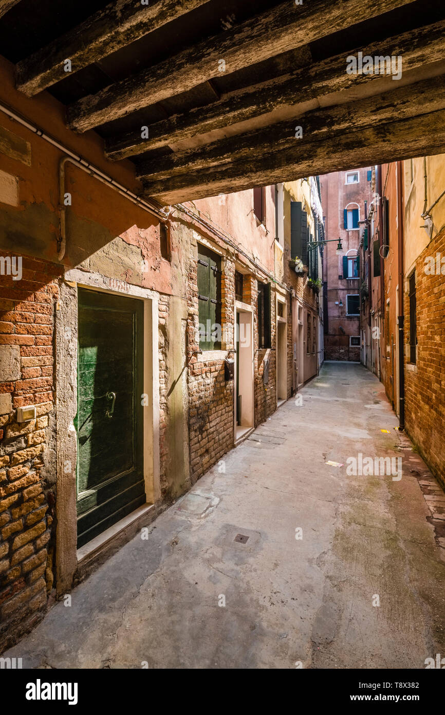 Narrow street leading through the ailing brick houses of the so-called 'Floating city' Stock Photo