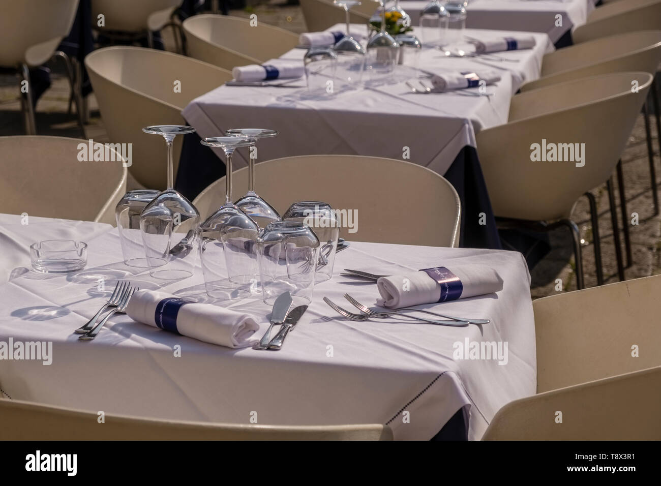 A table set with cutlery and glasses in the streets of the so-called 'Floating city' Stock Photo