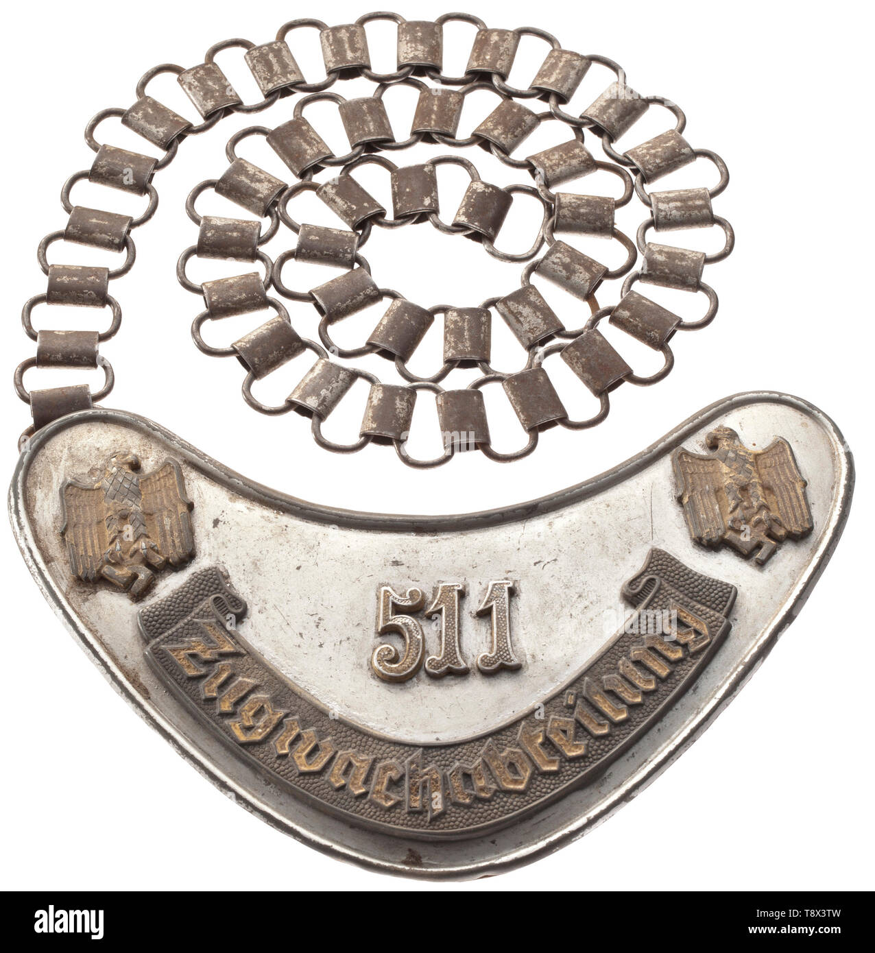 A gorget 'Zugwachabteilung 511' of the Wehrmacht service badge from 1942 Silver-coloured painted shield with applied grey bandeau 'Zugwachabteilung', with this inscription as well as both national eagles at the corners and the number '511' all highlighted in luminescent paint. Pressed paper liner, iron clasps and chain for wear. The train security guards were established by the beginning of the war as ancillary organisational units due to the heightened military traffic volumes. These small units were, like those of the military police, broadly autonomous and answerable to , Editorial-Use-Only Stock Photo