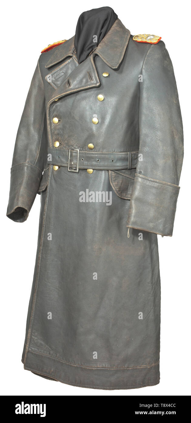 A leather overcoat for a Generalmajor maker Schuchart & Tschache, Dresden Luxury pre-war issue in high quality grey leather with 'real' cuffs, the gilt buttons with long eyelets and ring attachment. The detachable red underlay (moth traces) shoulder boards braided with gold cellon cording with centred silver edge cord. The long back slit with closure buttons and interior leather strips and loops to secure the lower end of the coat like chausses when riding or motorcycling, the field-grey silk liner with corresponding tailor's tag and an opening for the sidearm. Windbreaks w, Editorial-Use-Only Stock Photo