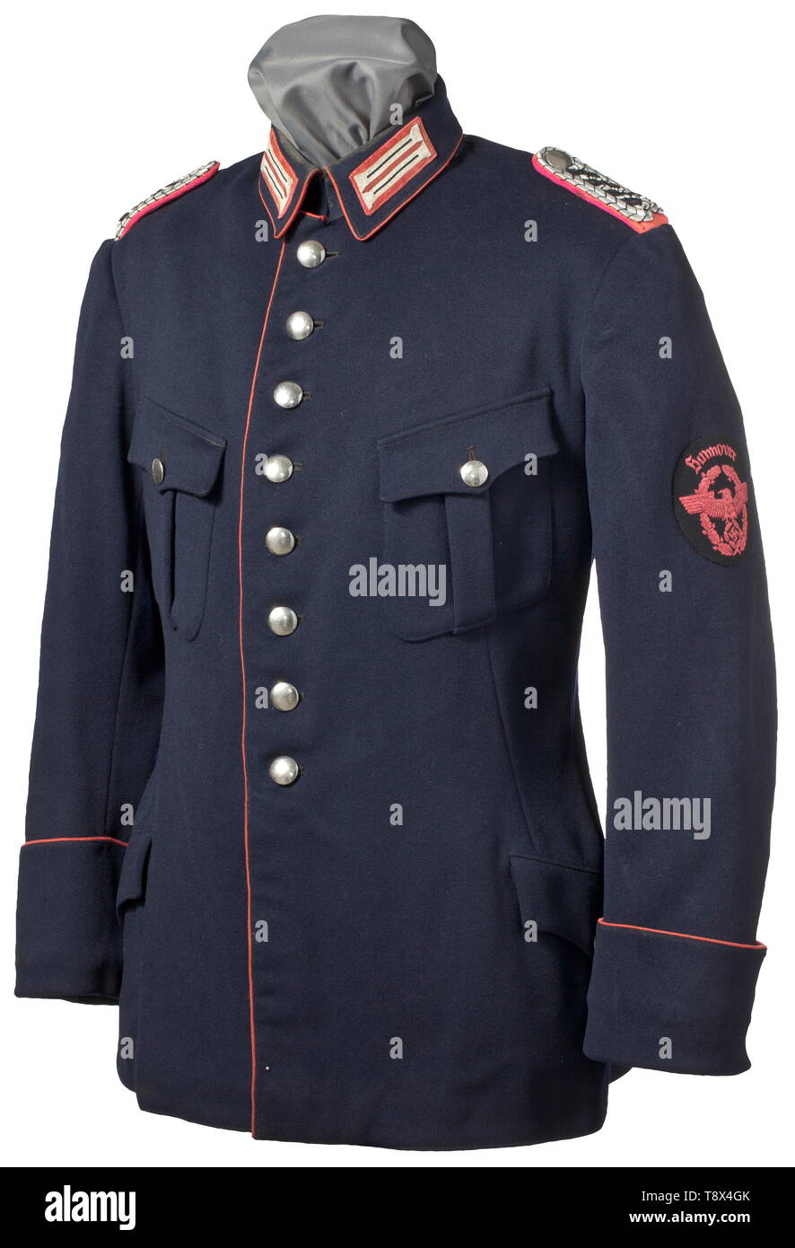 A coat for a Meister (Senior NCO) of the fire brigade/fire protection police Hannover inherited old style coat from the Weimar period Fine dark blue woollen cloth, silver buttons, crimson piping and insignia. Hand-embroidered crimson sleeve eagle with lettering 'Hannover' on black base. historic, historical, 20th century, Additional-Rights-Clearance-Info-Not-Available Stock Photo