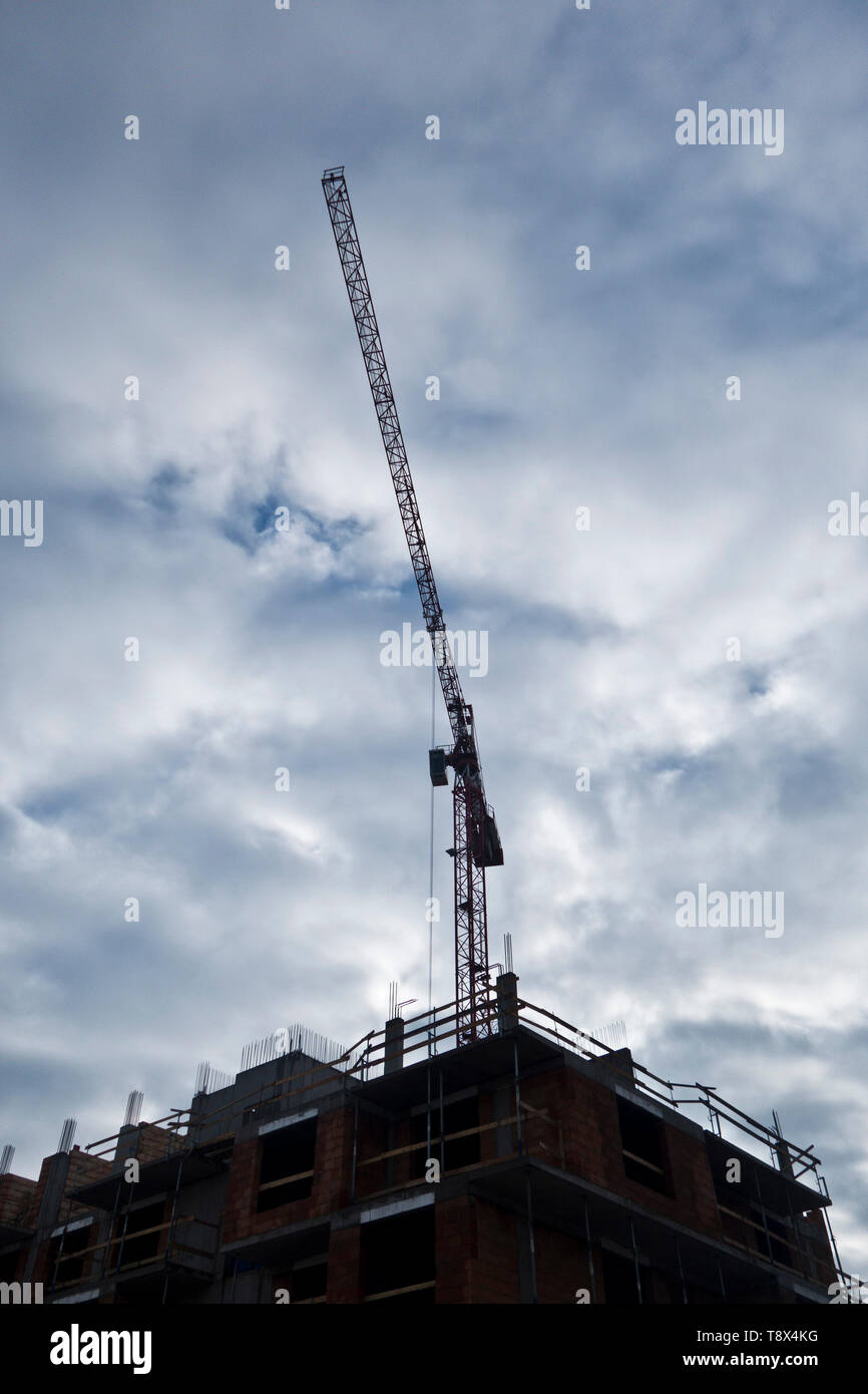 construction crane at a construction site for a new residential multi-story building Stock Photo