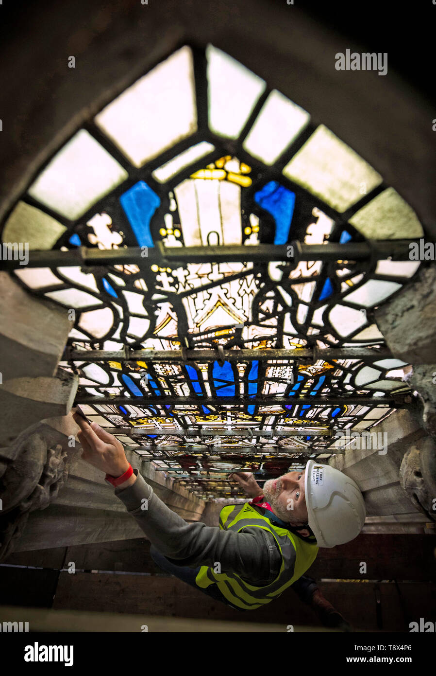 Conservation manager Nick Teed removes a stained glass windows panel
