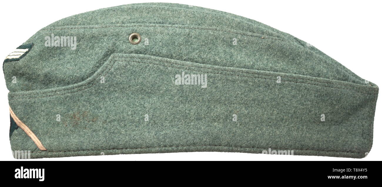 A garrison cap M 38 'Schiffchen' for enlisted men/NCOs of panzer troops Depot piece of field-grey woollen cloth, field-grey painted fine zinc ventilation rivets, brownish inner liner with faded maker's stamping, BeVo weave insignia on a dark green ground, pink soutache chevron. Light signs of usage and age. historic, historical, army, armies, armed forces, military, militaria, object, objects, stills, clipping, clippings, cut out, cut-out, cut-outs, 20th century, Editorial-Use-Only Stock Photo