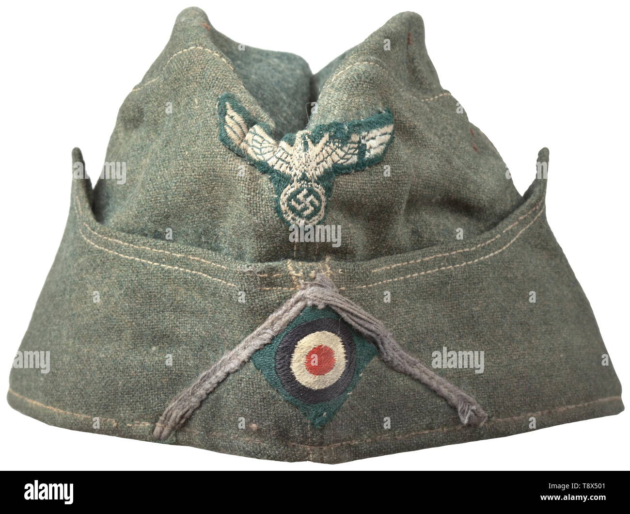 A garrison cap M 38 'Schiffchen' for enlisted men/NCOs of motorised units Depot piece of field-grey woollen cloth, field-grey painted zinc ventilation rivets, grey-green inner liner, BeVo weave insignia on a green ground, light blue (somewhat washed-out) soutache chevron. Signs of usage and age. historic, historical, army, armies, armed forces, military, militaria, object, objects, stills, clipping, clippings, cut out, cut-out, cut-outs, 20th century, Editorial-Use-Only Stock Photo