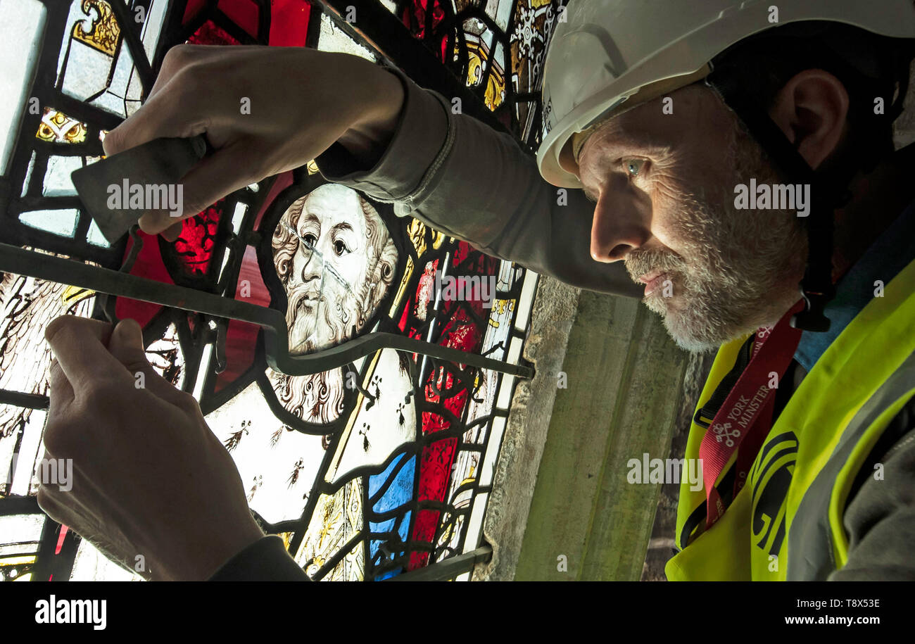 Conservation Manager Nick Teed removes a stained glass window during