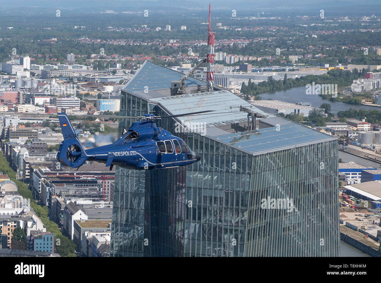 15 May 2019, Hessen, Frankfurt/Main: A Eurocopter EC 155 helicopter of the German Federal Police flies over the ECB in Frankfurt. The helicopters are ready for action within a very short time and can be used to prosecute perpetrators on the ground, to relocate special units or to monitor railway lines and airports. Photo: Boris Roessler/dpa Stock Photo