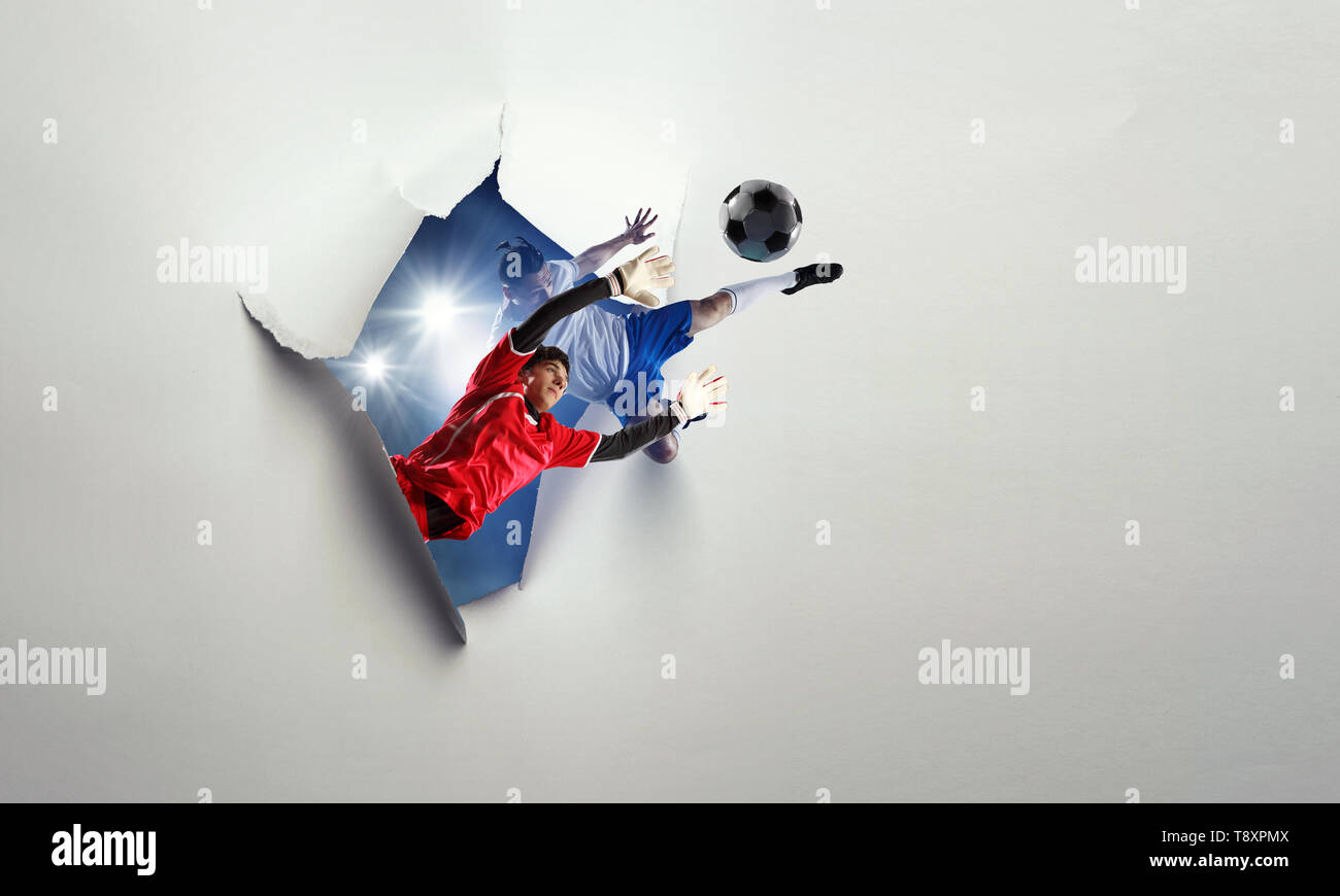 Paper breakthrough hole effect and soccer players. Mixed media Stock