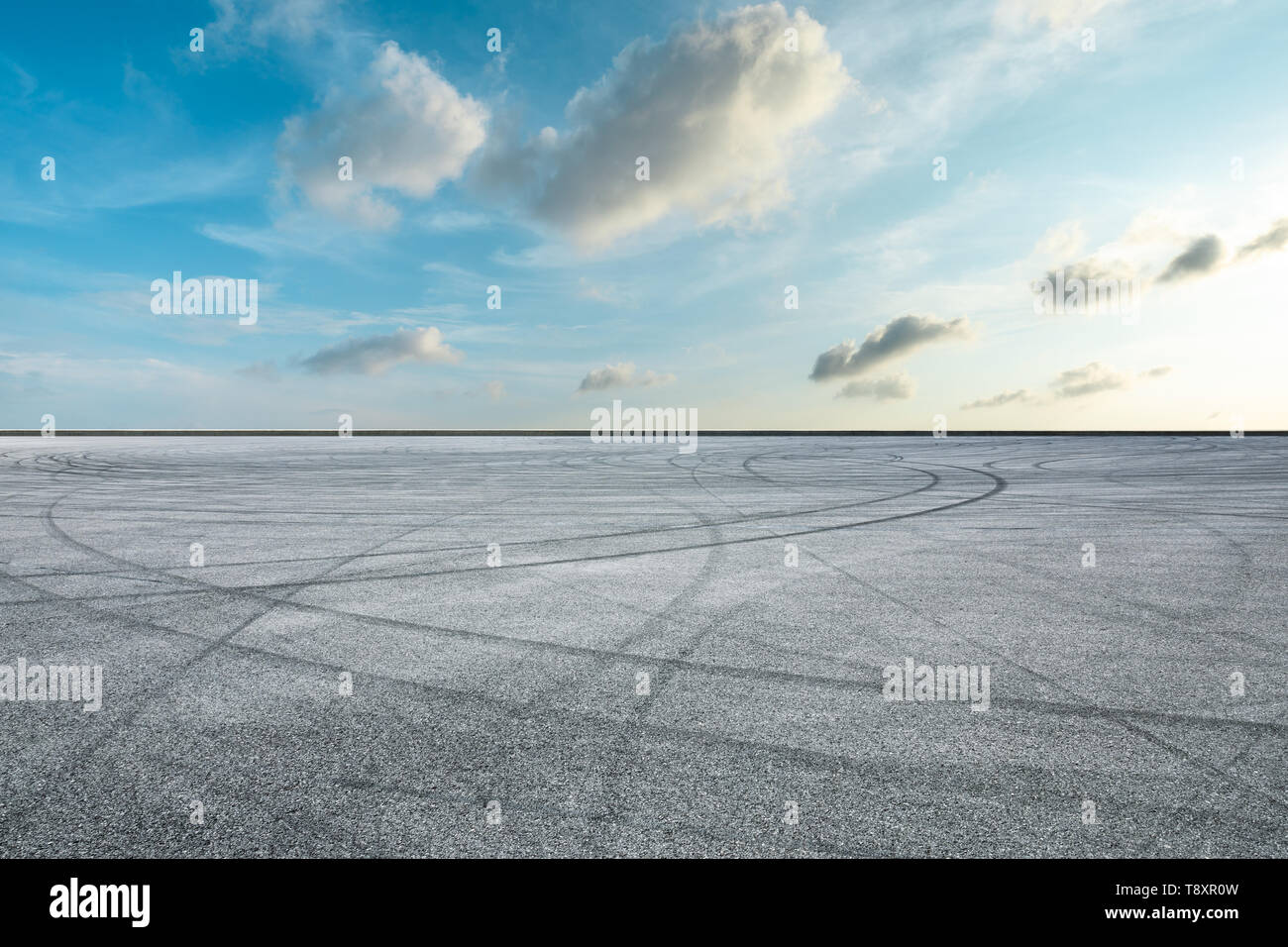 Asphalt race track ground and beautiful sky clouds at sunrise Stock Photo Alamy