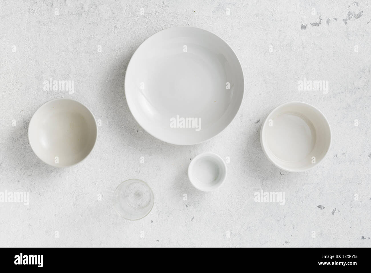 Set of empty plates on a white background top view Stock Photo - Alamy