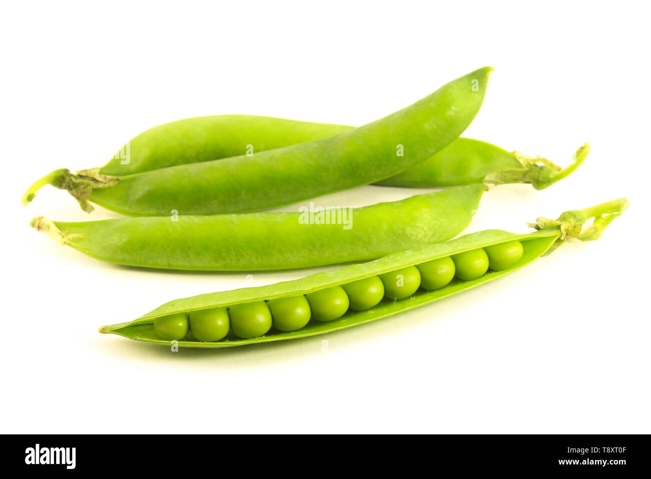 Pods of green peas close-up isolated on white Stock Photo