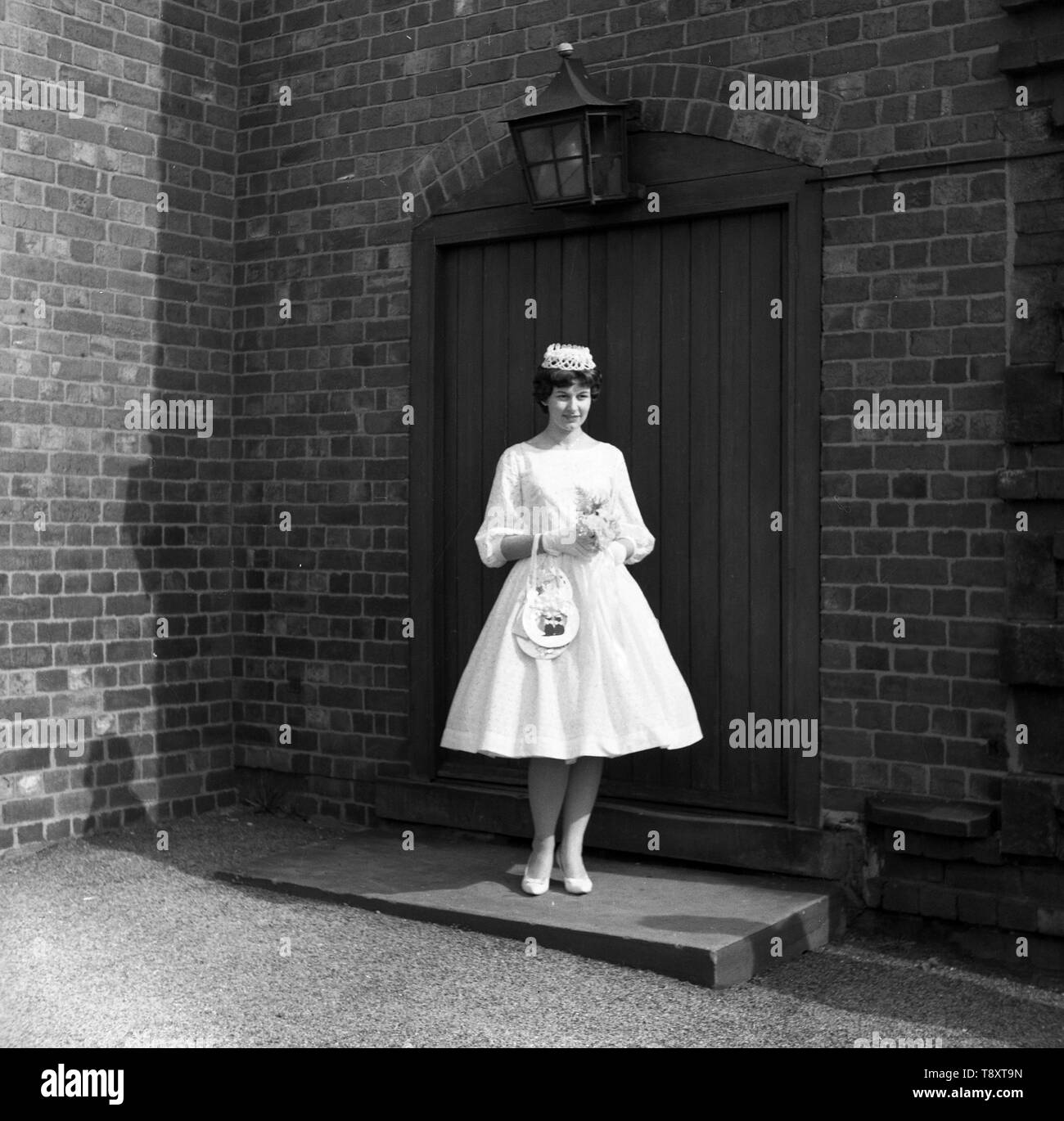 A wedding in the UK c1960  Bride in pretty flared short dress poses  Photo by Tony Henshaw Stock Photo