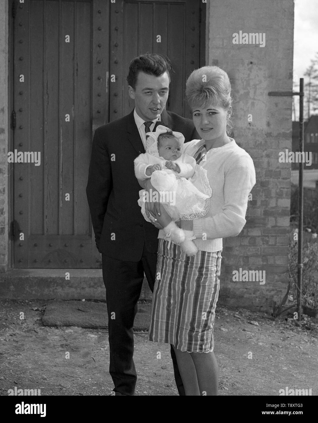 A Baby Christening in the UK c1962  Parents and baby  Photo by Tony Henshaw Stock Photo
