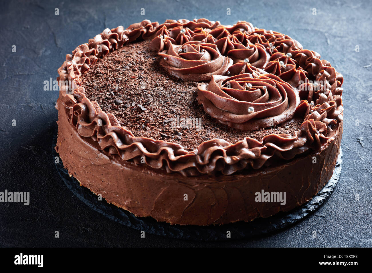 Close Up Of A Chocolate Meringue Festive Cake Topped With Chocolate Buttercream Roses And Silver Edible Dragee Horizontal Side View From Above Macro Stock Photo Alamy