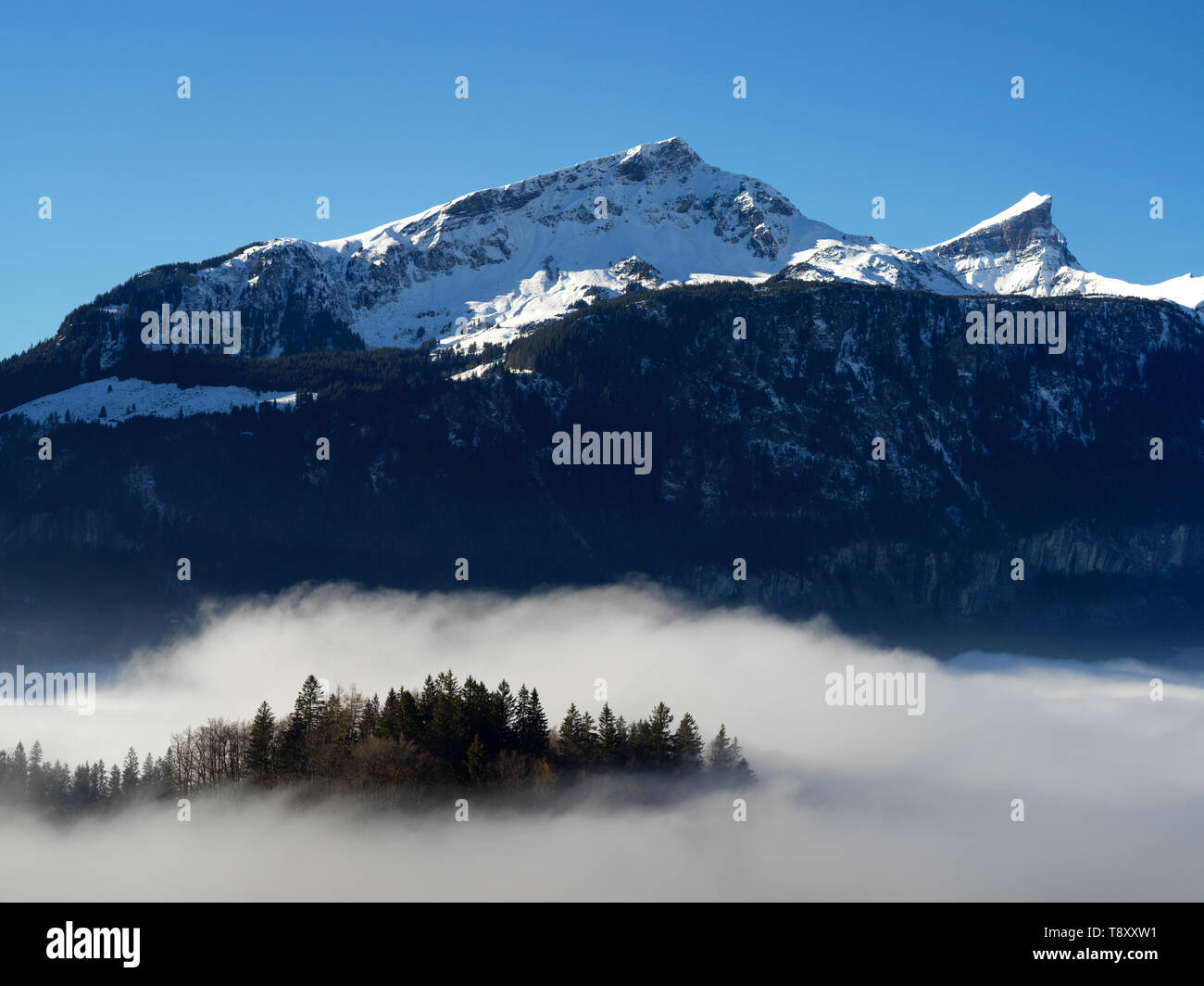 Clouds coming up from down in the valley near Hasliberg Meiringen Switzerland Stock Photo