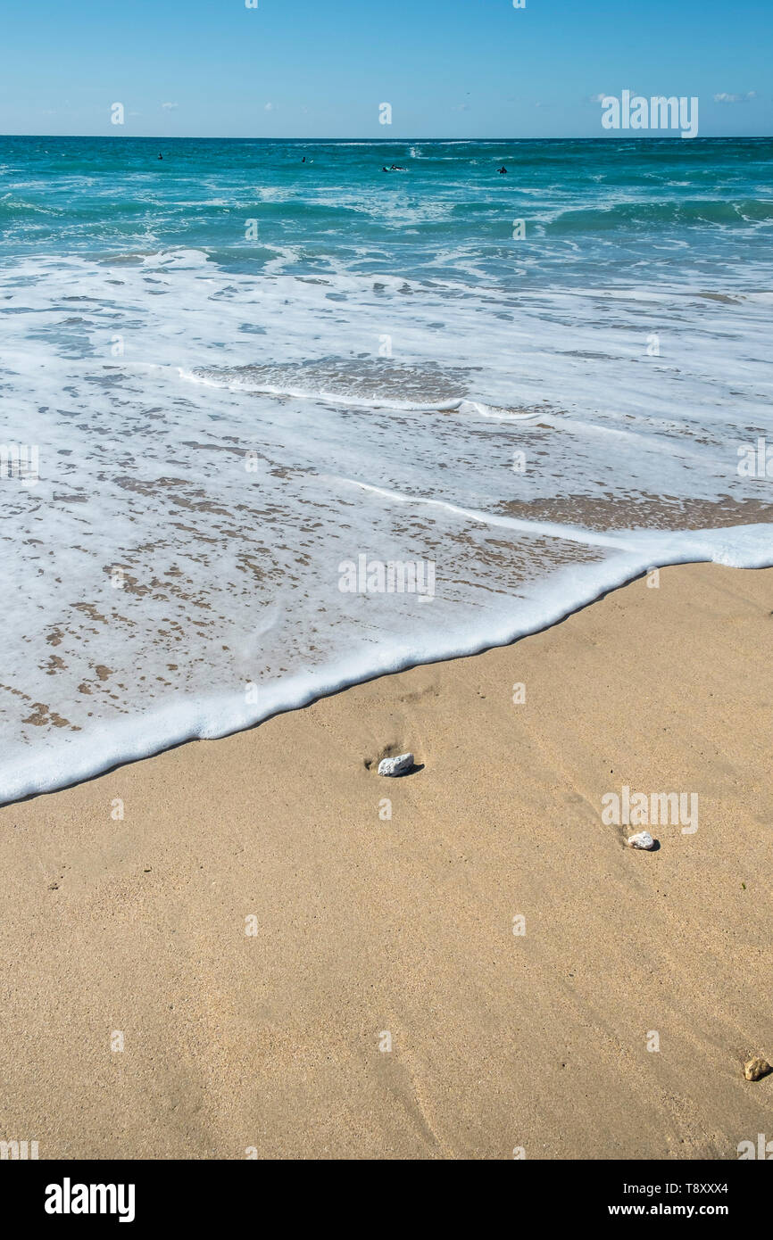 Incoming tide gently covering the sand on Fistral beach in Newquay in Cornwall. Stock Photo