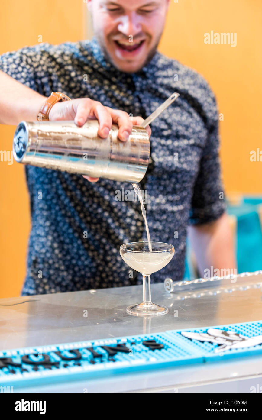 A bartender pouring a cocktail at a pop up bar at Trebah Garden in Cornwall. Stock Photo