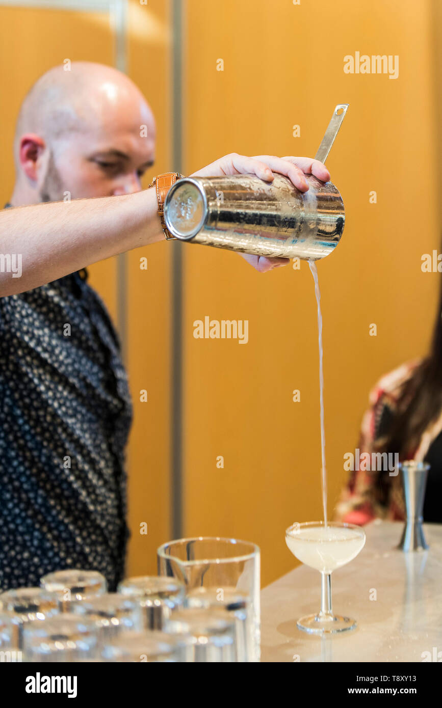 A bartender pouring a cocktail at a pop up bar at Trebah Garden in Cornwall. Stock Photo