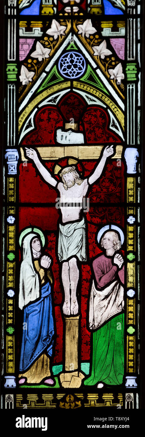 Stained glass window depicting crucifixion Jesus Christ on the Cross circa 1852 by William Wailes (1808-1881), Urchfont church, Wiltshire, England, UK Stock Photo