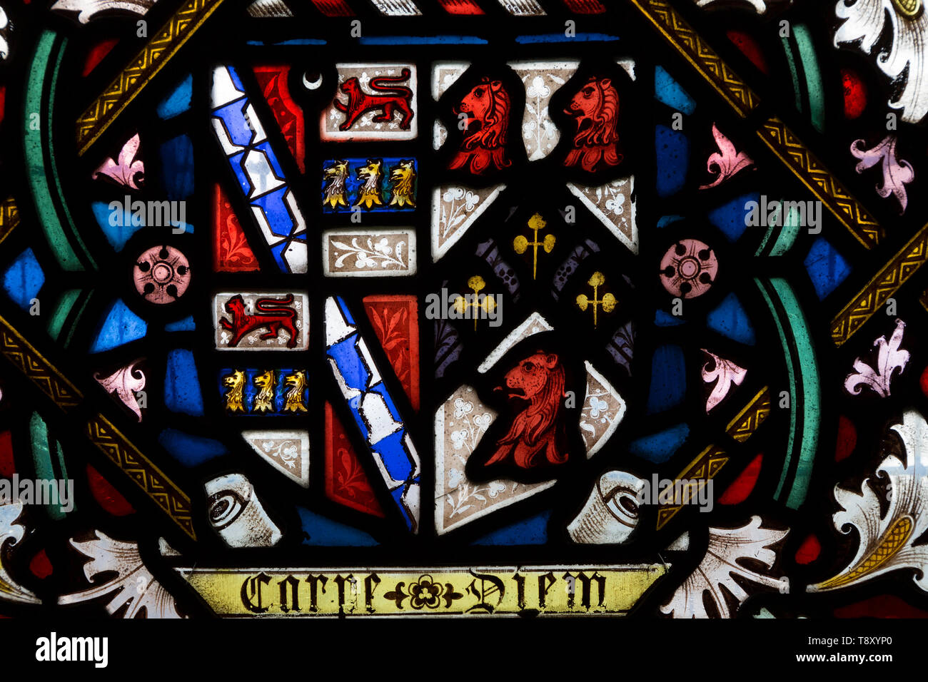 Stained glass window with flowers and floral and Coat of Arms decoration, All Saints church, Stanton St Bernard, Wiltshire circa 1850 England, UK Stock Photo